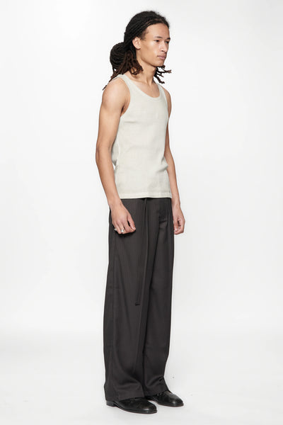 Side view of a person wearing a beige tank top and Limit Suit Trouser Classic Pinstripe by Beach Brains