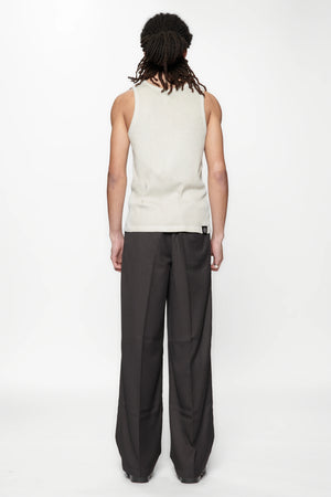 Behind view of a person wearing a beige tank top and Limit Suit Trouser Classic Pinstripe by Beach Brains
