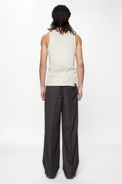 Behind view of a person wearing a beige tank top and Limit Suit Trouser Classic Pinstripe by Beach Brains
