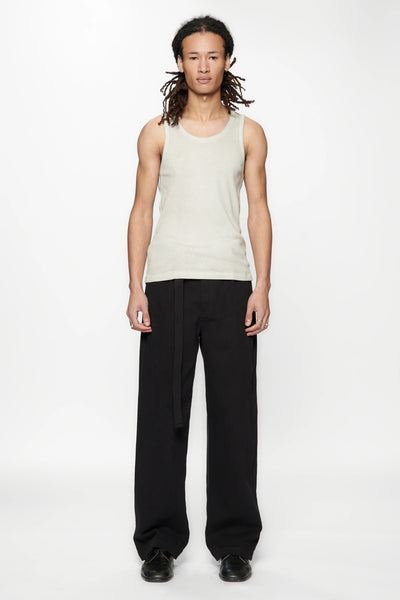 Person wearing a beige tank top and Pleated Work Pants in Black by Beach Brains