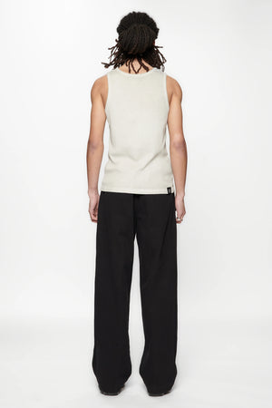 Behind view of a person wearing a beige tank top and Pleated Work Pants in Black by Beach Brains