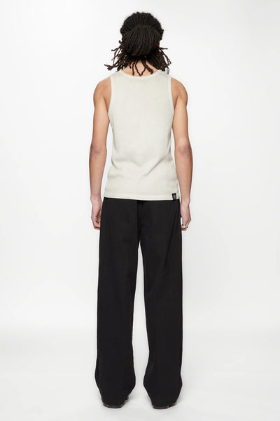Behind view of a person wearing a beige tank top and Pleated Work Pants in Black by Beach Brains